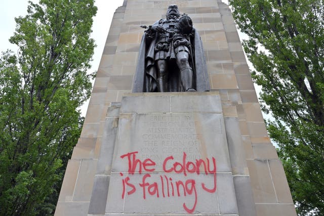 <p>Graffitti is seen on England's King George V statue</p>