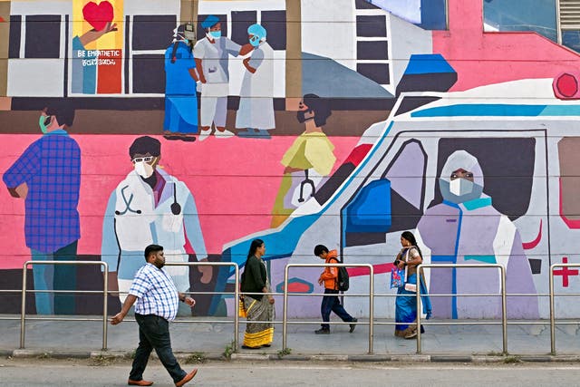 <p>File. Pedestrians walk past a wall mural promoting awareness on using face masks in Bengaluru, India, on 6 January 2025</p>
