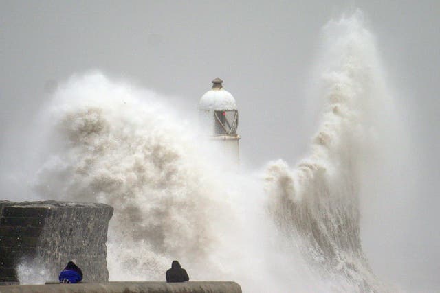 <p>Huge waves crash over the seafront in Porthcawl, south Wales, during Storm Darragh in December </p>