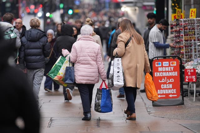 <p>Last-minute shoppers on London’s Oxford Street on Christmas Eve</p>