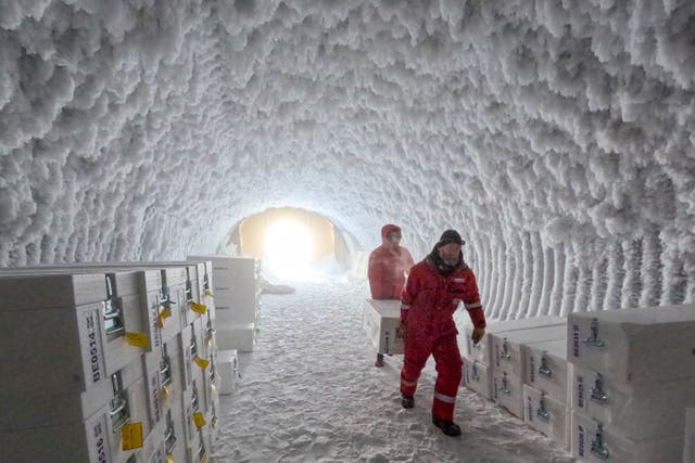 <p>People walk through an ice core storage cave at Little Dome C field base on Tuesday, Jan. 7, 2025, in in eastern Antarctica. (PNRA/IPEV Beyond Epica via AP)</p>