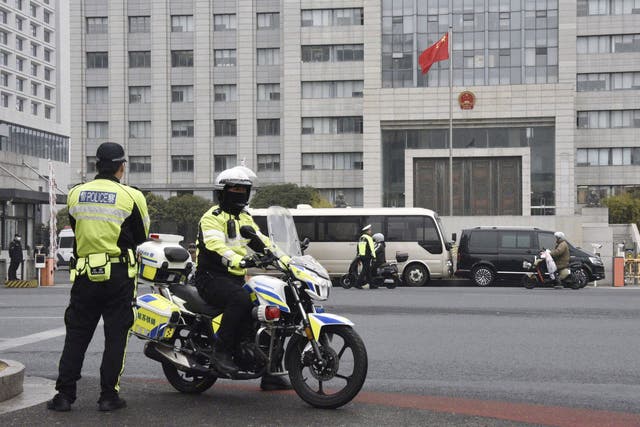 <p>Police officers patrol near the Jiangsu Suzhou Intermediate People’s Court in Suzhou, west of Shanghai, China</p>