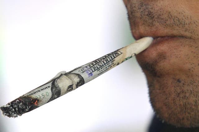 <p>A visitor smokes a joint during the first Cannabis Cup competition</p>