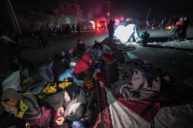 <p>Palestinians gather near a roadblock on the al Rashid Street as they wait to return to their destroyed homes in northern Gaza on 26 January 2025</p>