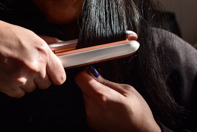 <p>A woman uses a flat iron to straighten her hair. Formaldehyde, a dangerous chemical found ‘nearly everywhere’ and used to help smooth curls, has been determined to present an ‘unreasonable risk of injury to human health, the Environmental Protection Agency said Thursday  </p>