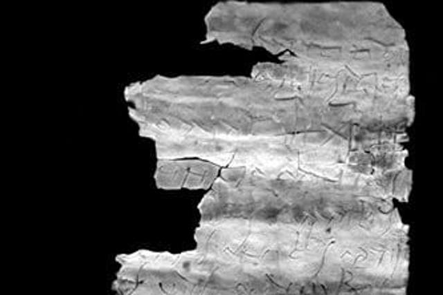 <p>The unrolled inscription inside third century amulet providing early references to the spread of Christianity </p>