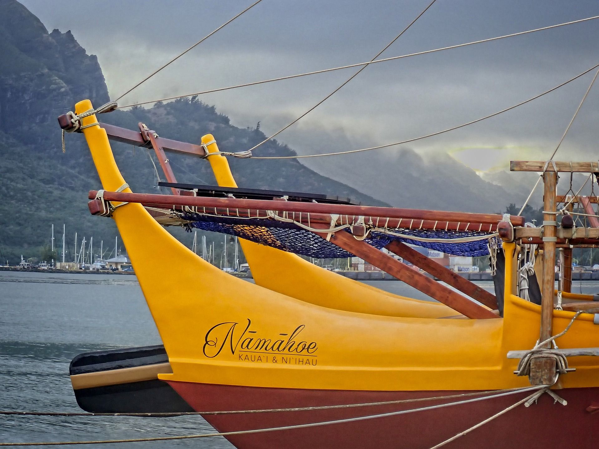 Yellow and brown polynesian style boat on water in the pacific