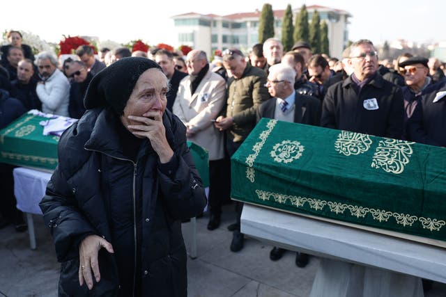 <p>Friends and relatives attend the funeral of Turkish journalist Nedim Turkmen and his family in Istanbul, Turkey, 22 January 2025. Turkish journalist Nedim Turkmen, his wife, and their two children died in a fire that broke out in a hotel at Kartalkaya ski resort, northwestern Turkey</p>